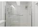 Bright shower featuring white tiled walls, glass door, safety bars and shower head at 244 Saint Augustine # 605, Venice, FL 34285