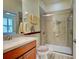 Well-appointed bathroom featuring a glass-enclosed shower, stylish vanity, and neutral decor at 275 Capulet Dr, Venice, FL 34292