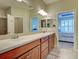 Bathroom has double sinks, a large mirror, and is conveniently located next to the bedroom at 275 Capulet Dr, Venice, FL 34292