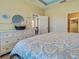 This primary bedroom features a dresser with a round mirror, and a patterned comforter at 275 Capulet Dr, Venice, FL 34292
