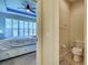 Bedroom that has a blue ceiling and ceiling fan, as well as a toilet room visible at 275 Capulet Dr, Venice, FL 34292