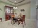 A cozy dining room with wooden table, hutch, neutral wall color, and tile floors at 275 Capulet Dr, Venice, FL 34292