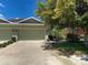Charming home featuring an attached two-car garage, lovely landscaping, and a well-manicured lawn at 275 Capulet Dr, Venice, FL 34292
