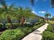 Lovely home exterior featuring well-maintained landscaping, including mature palm trees at 275 Capulet Dr, Venice, FL 34292