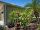 This home features colorful landscaping with red hibiscus and a mature palm tree at 275 Capulet Dr, Venice, FL 34292