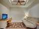 Flex room with tray ceiling with fan, desk, TV, futon and decorative rug at 275 Capulet Dr, Venice, FL 34292