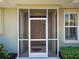 Exterior shot of a home's screened front porch and front door at 275 Capulet Dr, Venice, FL 34292