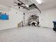 The garage has a clean epoxy floor with storage shelves and a ceiling fan at 275 Capulet Dr, Venice, FL 34292