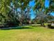 Expansive green space offering a serene and picturesque setting with mature trees and manicured lawns at 275 Capulet Dr, Venice, FL 34292