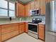 Well-equipped kitchen featuring stainless steel appliances, tile flooring, and ample cabinet space at 275 Capulet Dr, Venice, FL 34292