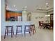 Open-concept kitchen with a breakfast bar, stainless steel appliances, and an adjacent dining area at 275 Capulet Dr, Venice, FL 34292