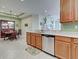 Bright kitchen featuring stainless steel appliances and breakfast bar adjoining an elegant dining area at 275 Capulet Dr, Venice, FL 34292