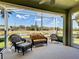 An inviting screened lanai offers scenic views and comfortable seating, perfect for outdoor relaxation at 275 Capulet Dr, Venice, FL 34292