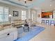 The living room opens to the kitchen and features a large window with shutters at 275 Capulet Dr, Venice, FL 34292