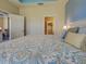 Main bedroom featuring blue accent wall with access to closet and living area at 275 Capulet Dr, Venice, FL 34292