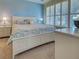 Main bedroom with blue accent wall, shuttered windows, and white dressers and night stands at 275 Capulet Dr, Venice, FL 34292