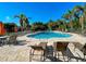Community pool offers a refreshing retreat with poolside seating and lush tropical landscaping at 275 Capulet Dr, Venice, FL 34292
