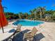 Community pool offers a refreshing retreat with poolside seating and lush tropical landscaping at 275 Capulet Dr, Venice, FL 34292