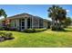 An attractive rear exterior view with a screened lanai and lush, green landscaping at 275 Capulet Dr, Venice, FL 34292