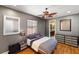 Stylish bedroom with modern decor, featuring hardwood floors, a cozy bed, and ample natural light from a window at 2750 Gocio Road Ext, Sarasota, FL 34235