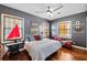 Inviting bedroom with stylish decor, featuring hardwood floors, a cozy bed, and ample natural light from the windows at 2750 Gocio Road Ext, Sarasota, FL 34235
