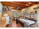 Rustic dining room featuring wood beams, unique tile floor and antique cabinets at 2750 Gocio Road Ext, Sarasota, FL 34235