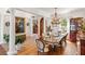 Elegant dining room featuring a wooden table with chandelier, columns and artistic decor at 2750 Gocio Road Ext, Sarasota, FL 34235