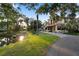 Beautiful home with a tile roof surrounded by mature trees and a pond at 2750 Gocio Road Ext, Sarasota, FL 34235