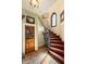 Foyer featuring tile flooring, wooden staircase, decorative accents, and custom lighting at 2750 Gocio Road Ext, Sarasota, FL 34235