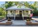 Charming exterior view of updated home with a welcoming front porch and American flag at 2750 Gocio Road Ext, Sarasota, FL 34235