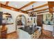 Open kitchen with island, stone arches, beam ceilings and chef's pantry at 2750 Gocio Road Ext, Sarasota, FL 34235