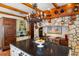 Kitchen with dark granite island, stone accents, and rustic hanging decor at 2750 Gocio Road Ext, Sarasota, FL 34235