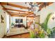 Bright living room with wooden beams, decorative chandelier, and open floor plan at 2750 Gocio Road Ext, Sarasota, FL 34235