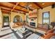 Cozy living room with wood ceiling beams, fireplace, and comfortable built-in seating at 2750 Gocio Road Ext, Sarasota, FL 34235