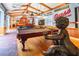 Nautical themed living room featuring custom boat bar, pool table, wood beams and hardwood floors at 2750 Gocio Road Ext, Sarasota, FL 34235