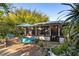 Charming outdoor patio with dining table and screened-in porch, perfect for enjoying the outdoors at 2750 Gocio Road Ext, Sarasota, FL 34235