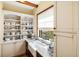 Bright pantry featuring white cabinets, marble counter and a farmhouse sink at 2750 Gocio Road Ext, Sarasota, FL 34235