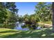 Serene pond surrounded by lush greenery, creating a peaceful and private outdoor space at 2750 Gocio Road Ext, Sarasota, FL 34235
