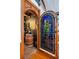 Wine cellar featuring a stained-glass door, custom lighting and wooden barrels at 2750 Gocio Road Ext, Sarasota, FL 34235