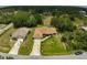 Aerial view of a single-Gathering home in a neighborhood with well-maintained lawns and mature landscaping at 2834 Coolidge Ave, North Port, FL 34286