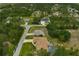Aerial view showcasing a property with a pool, surrounded by lush green trees in a quiet neighborhood at 2834 Coolidge Ave, North Port, FL 34286