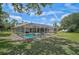 Expansive backyard featuring a screened-in pool area perfect for outdoor relaxation and activities at 2834 Coolidge Ave, North Port, FL 34286