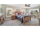 Relaxing bedroom with soft carpet, natural light, and a cozy quilt on the bed at 2834 Coolidge Ave, North Port, FL 34286