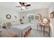Bedroom featuring neutral walls, a ceiling fan, and a charming moon-themed decor for a whimsical touch at 2834 Coolidge Ave, North Port, FL 34286