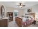 Bedroom showcasing a wooden bed, dresser, nightstand, and natural light at 2834 Coolidge Ave, North Port, FL 34286