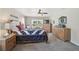 Comfortable bedroom featuring a bed, dressers, and a chair beside a window at 2834 Coolidge Ave, North Port, FL 34286