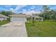 Charming single-story home with a well-manicured lawn, mature landscaping, and a spacious two-car garage at 2834 Coolidge Ave, North Port, FL 34286
