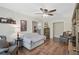 Cozy living room featuring hardwood floors, a ceiling fan, and comfortable seating arrangements at 2834 Coolidge Ave, North Port, FL 34286