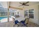 Outdoor patio with table and chairs, ideal for dining or relaxation next to the screened pool at 2834 Coolidge Ave, North Port, FL 34286
