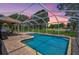 Screened-in pool with a brick patio, perfect for outdoor relaxation and enjoyment at 2834 Coolidge Ave, North Port, FL 34286